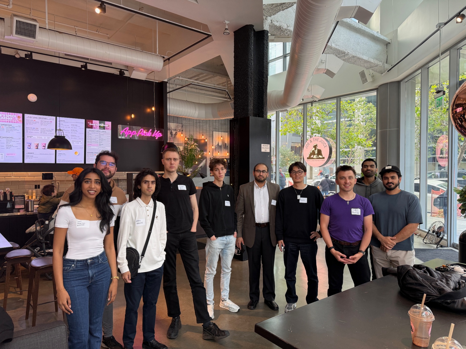 Founders group photo, cafe backdrop