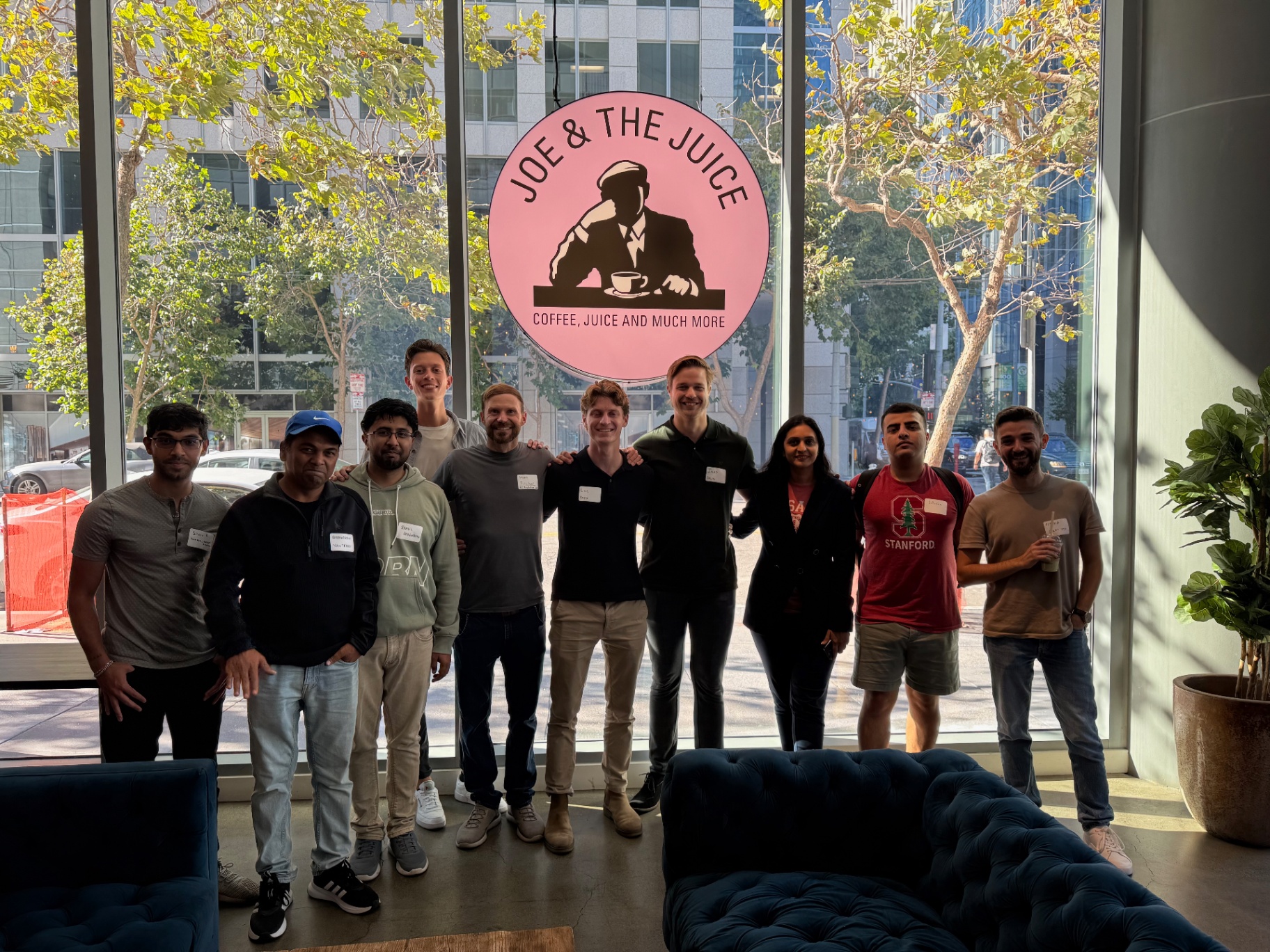 Founders group photo under the pink Joe & The Juice sign