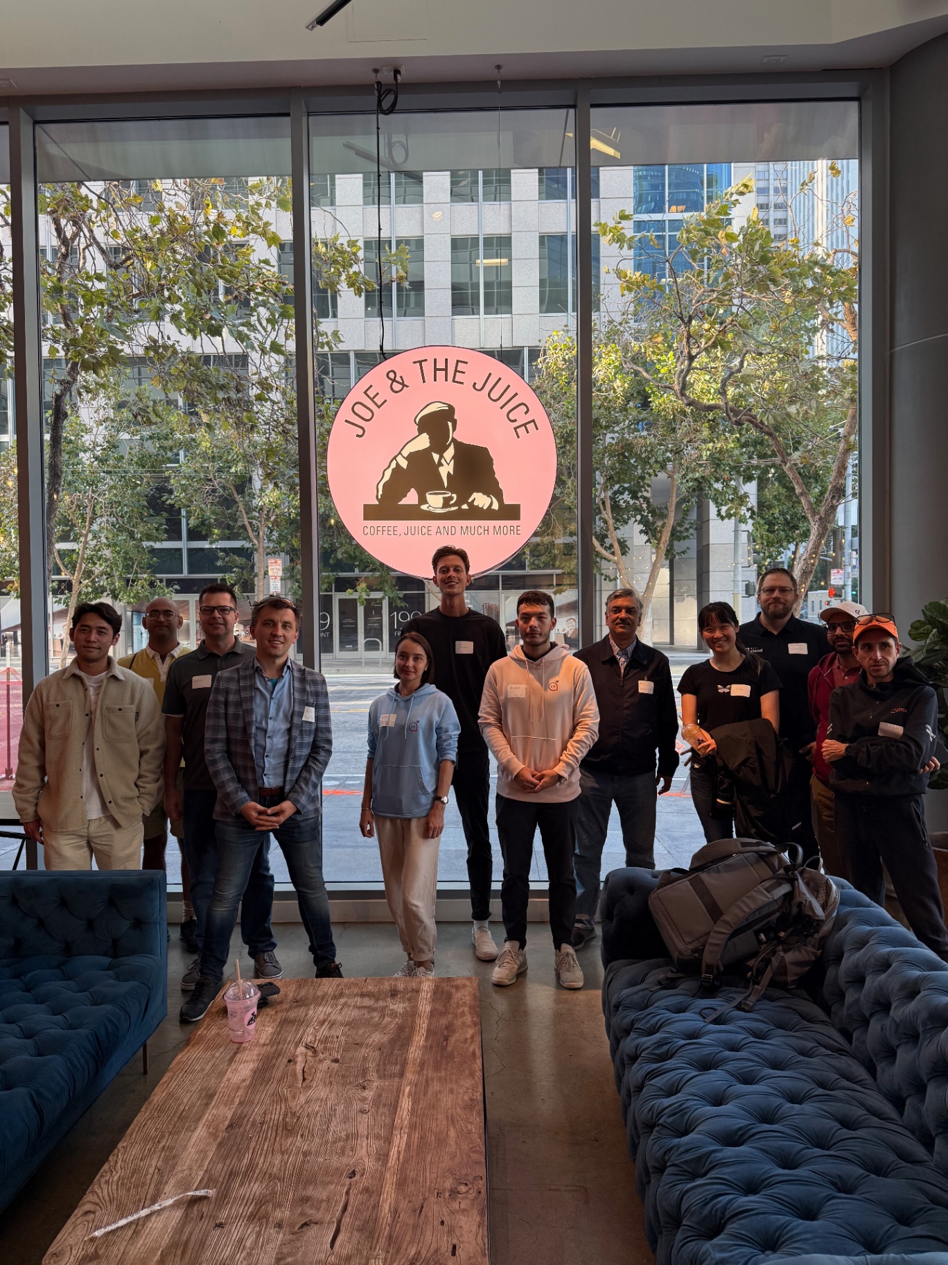 Wide group of founders in the sunlit venue lounge