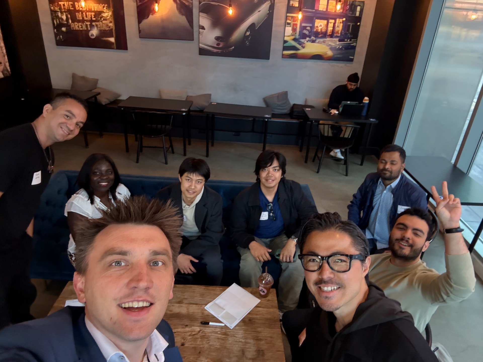 Host selfie with founders seated around the table