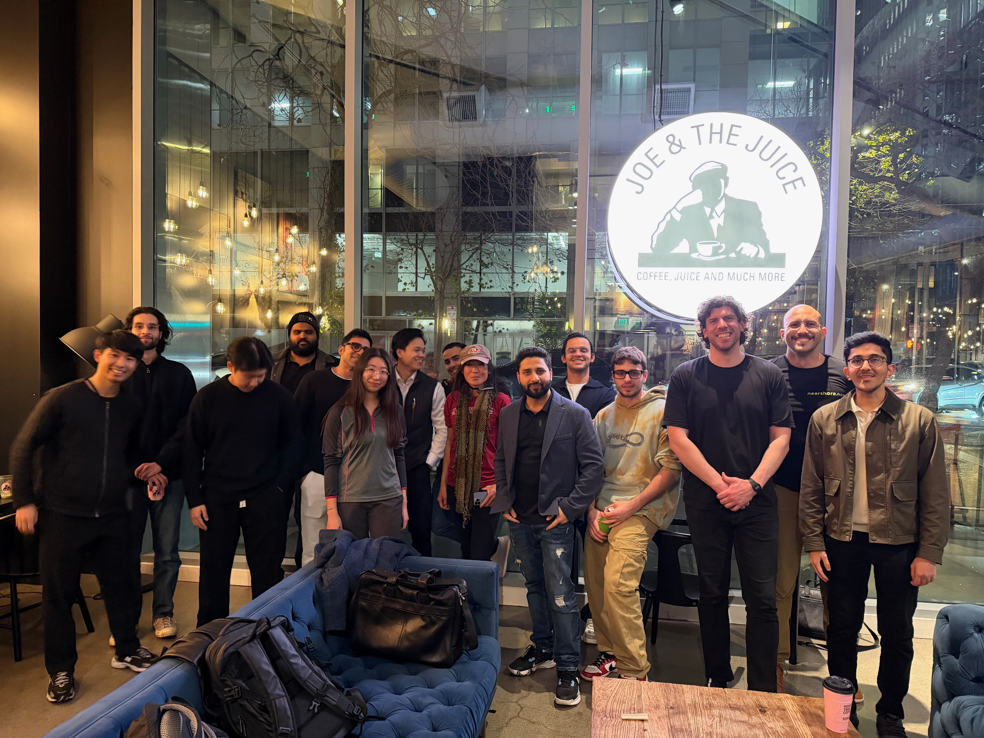 Founders group photo in front of the Joe & The Juice sign at night