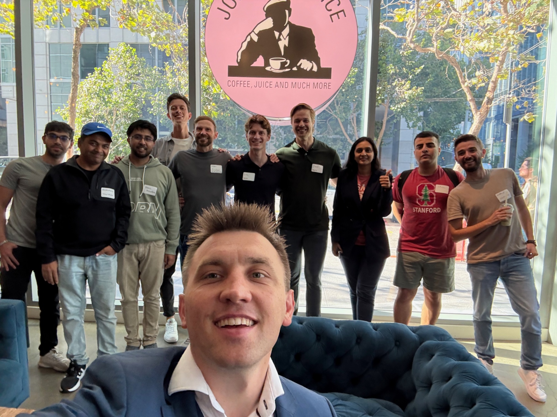 Selfie of the host with founders behind him at the venue